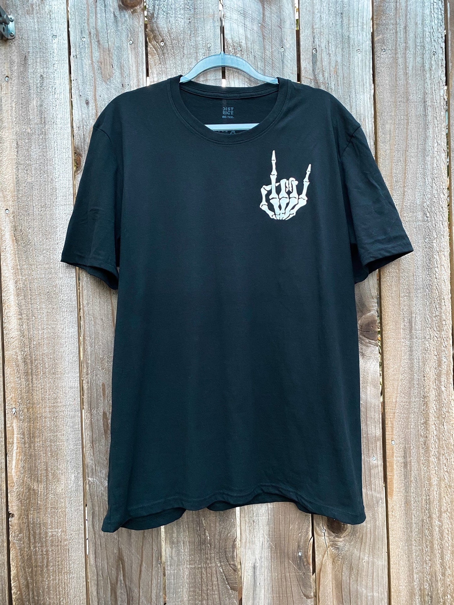 Black T-shirt with a metallic silver skeleton hand in the rock on position!